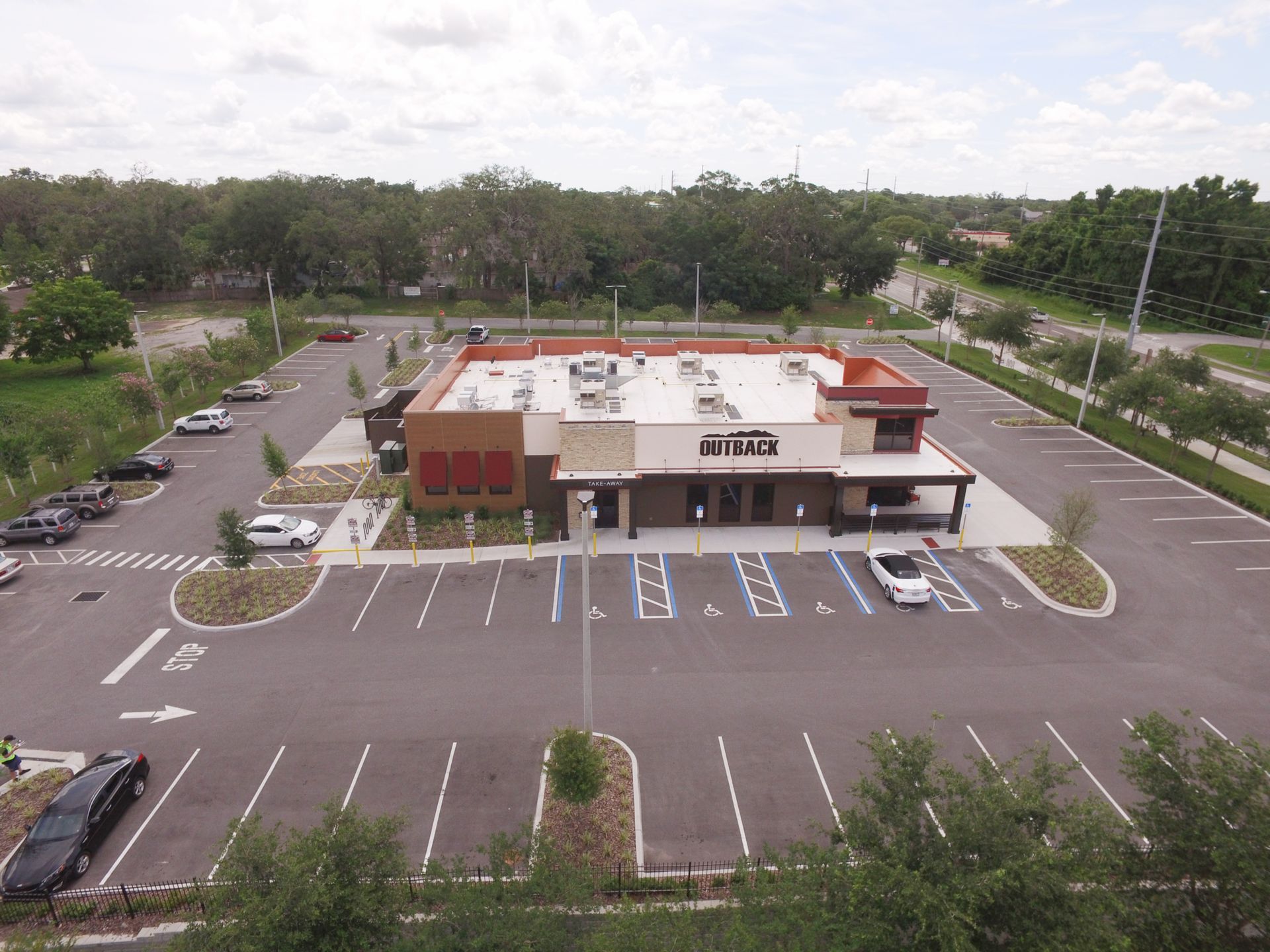 An aerial view of a restaurant with a parking lot in front of it