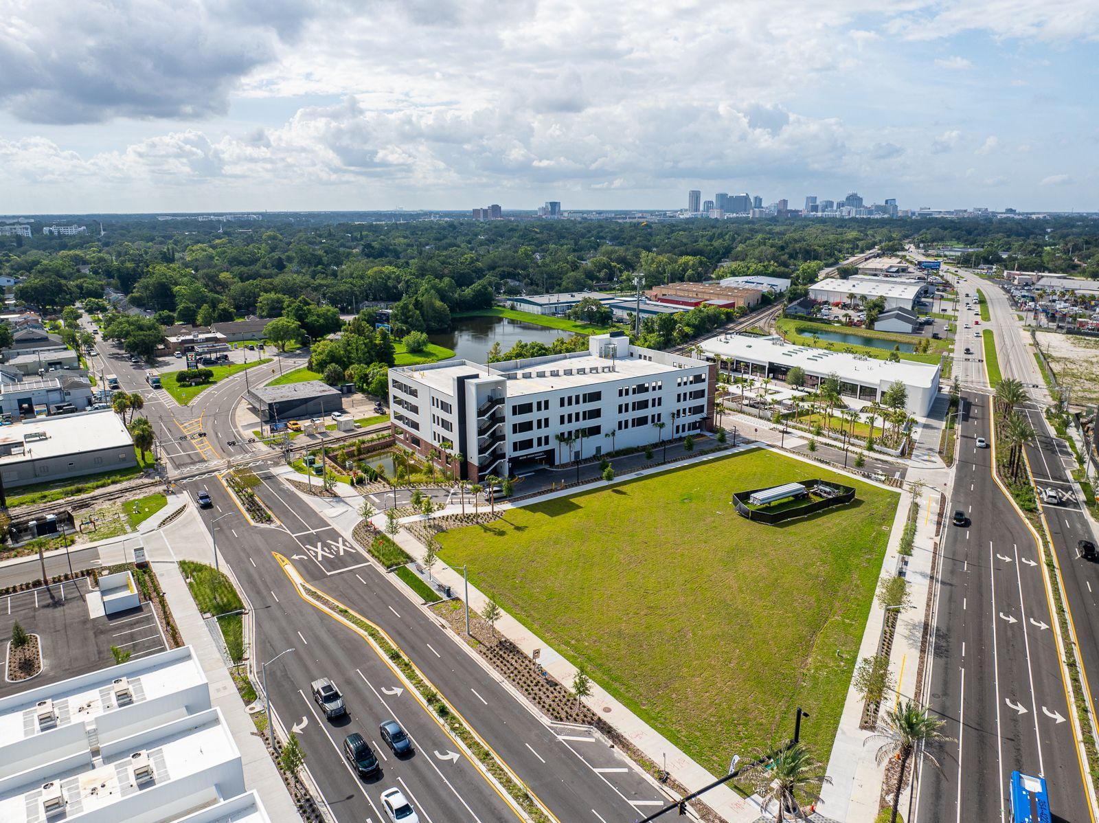 An aerial view of a city with a large building in the middle of it.