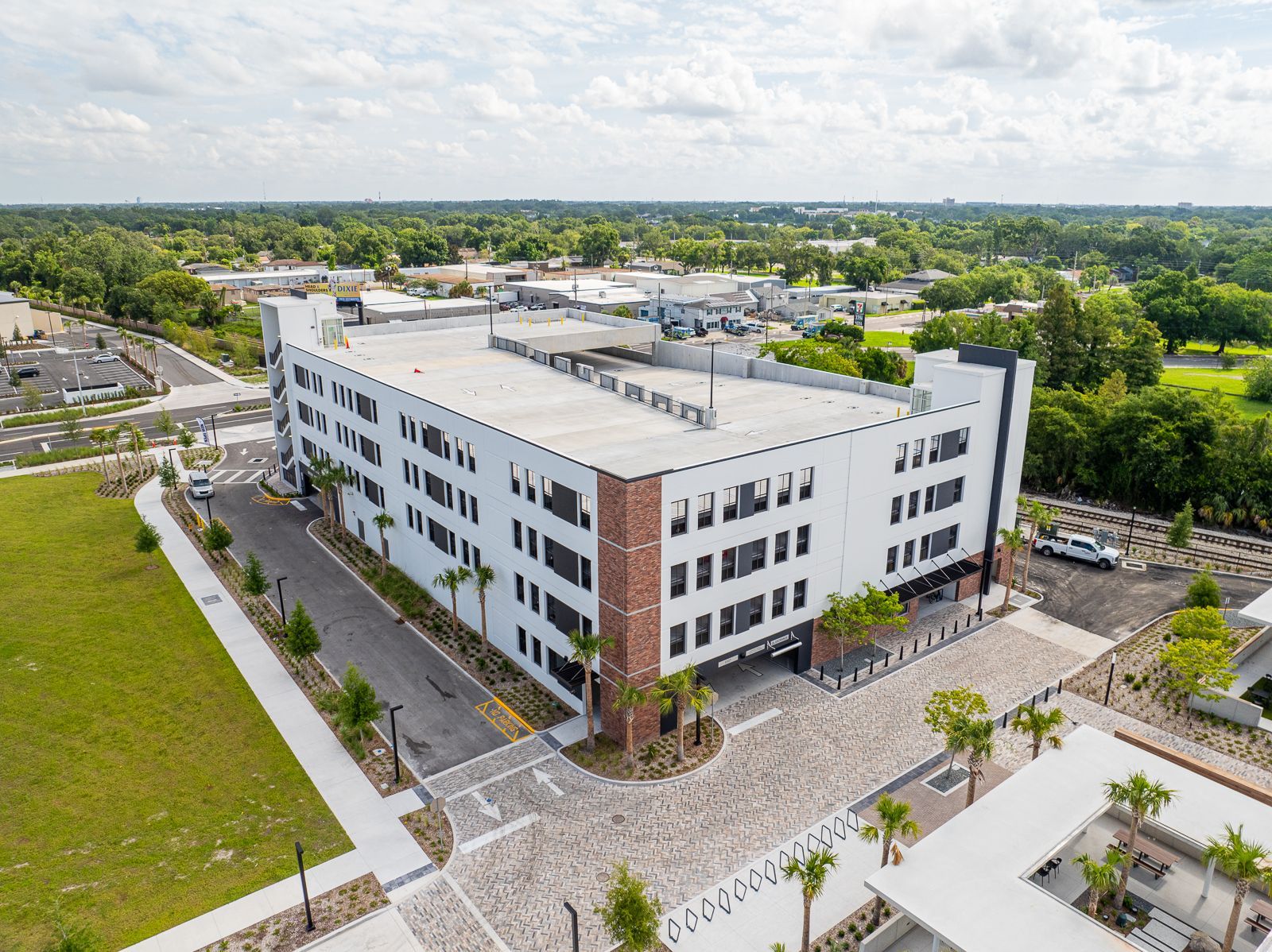 An aerial view of a large building with a lot of cars parked in front of it.