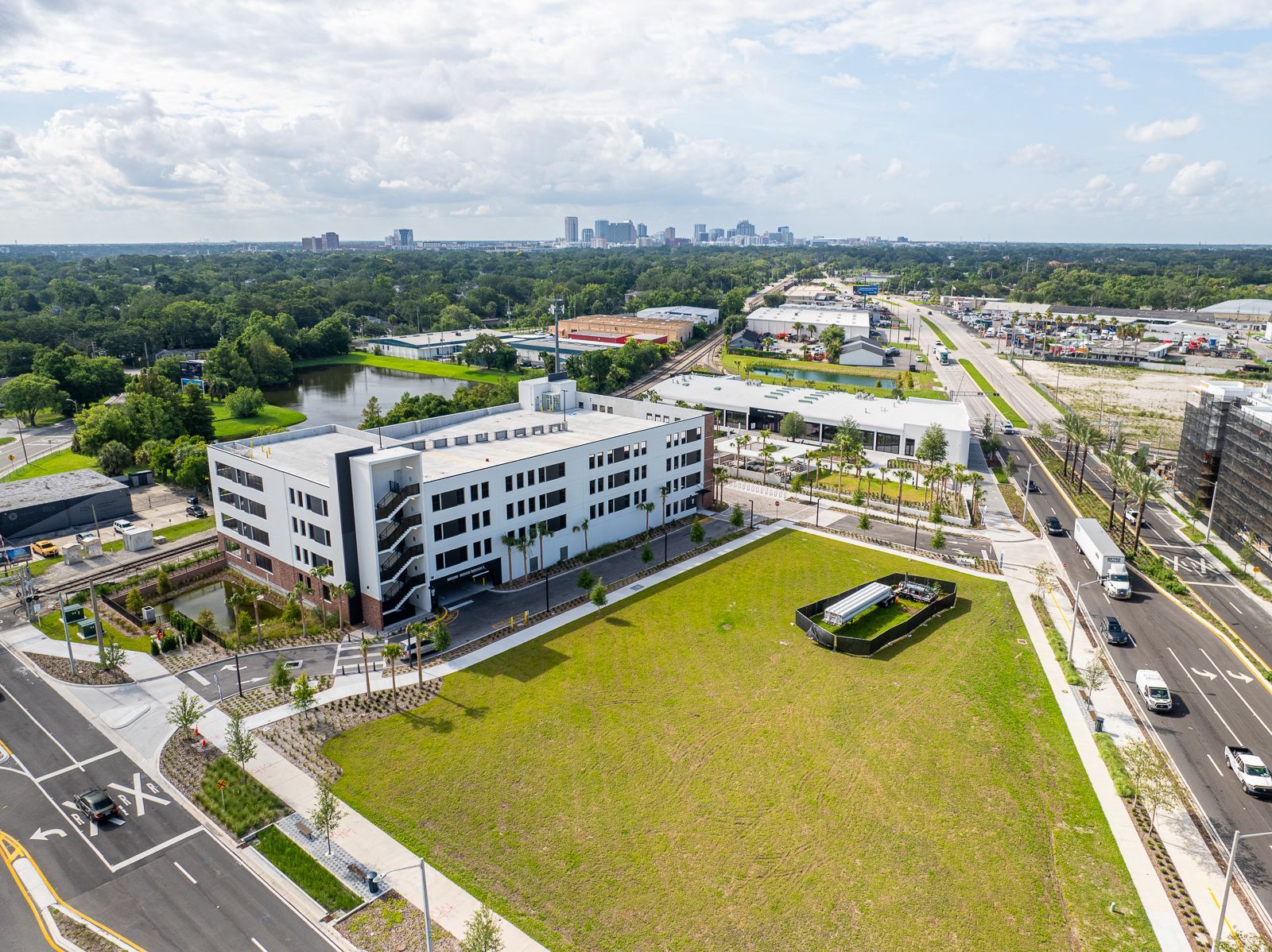 An aerial view of a large building with a large grassy area in front of it.