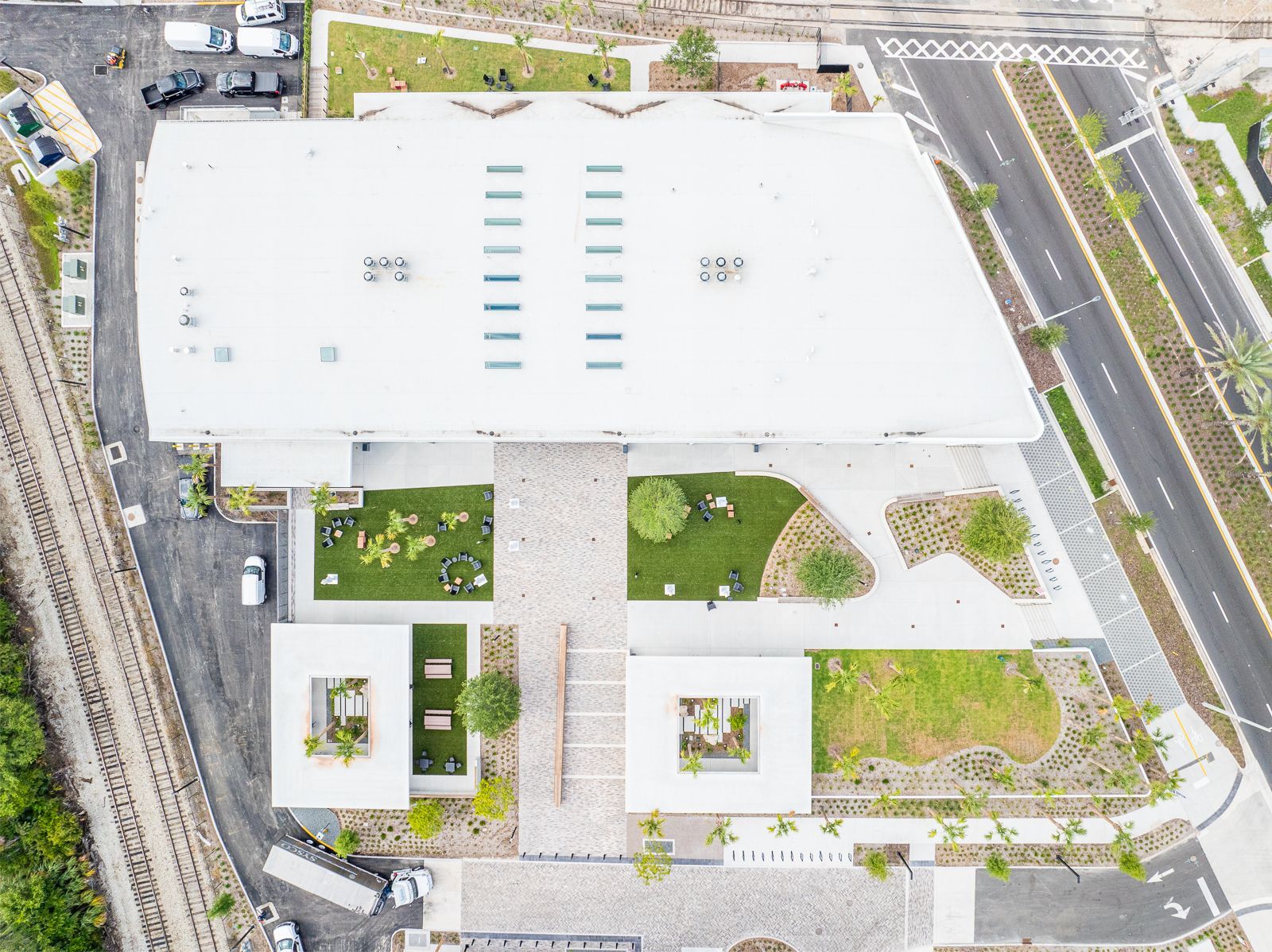 An aerial view of a large white building with a white roof