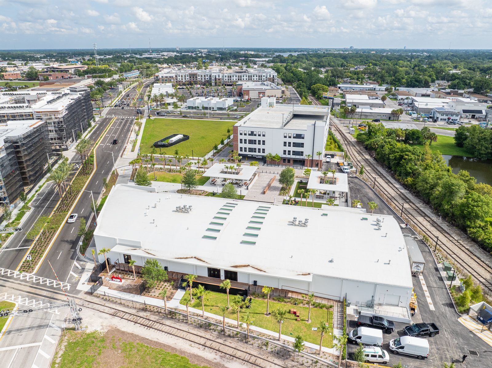 An aerial view of a large white building in the middle of a city.