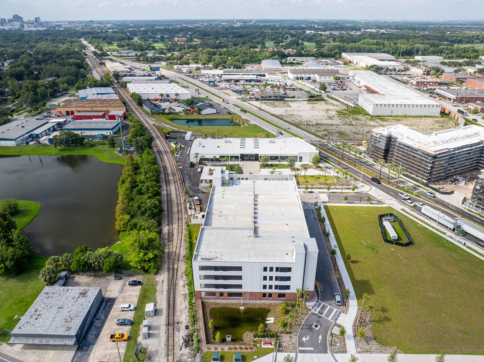 An aerial view of a city with a large building in the middle of it.