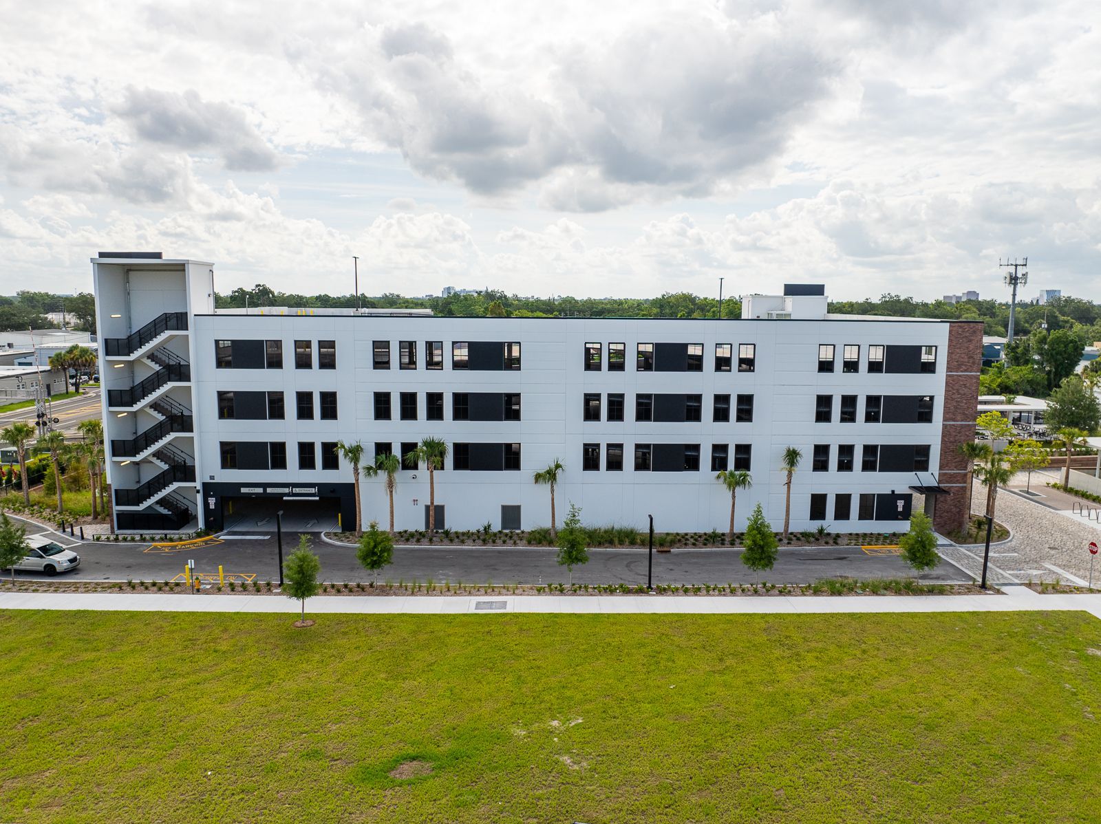 An aerial view of a large white building with stairs leading up to it.