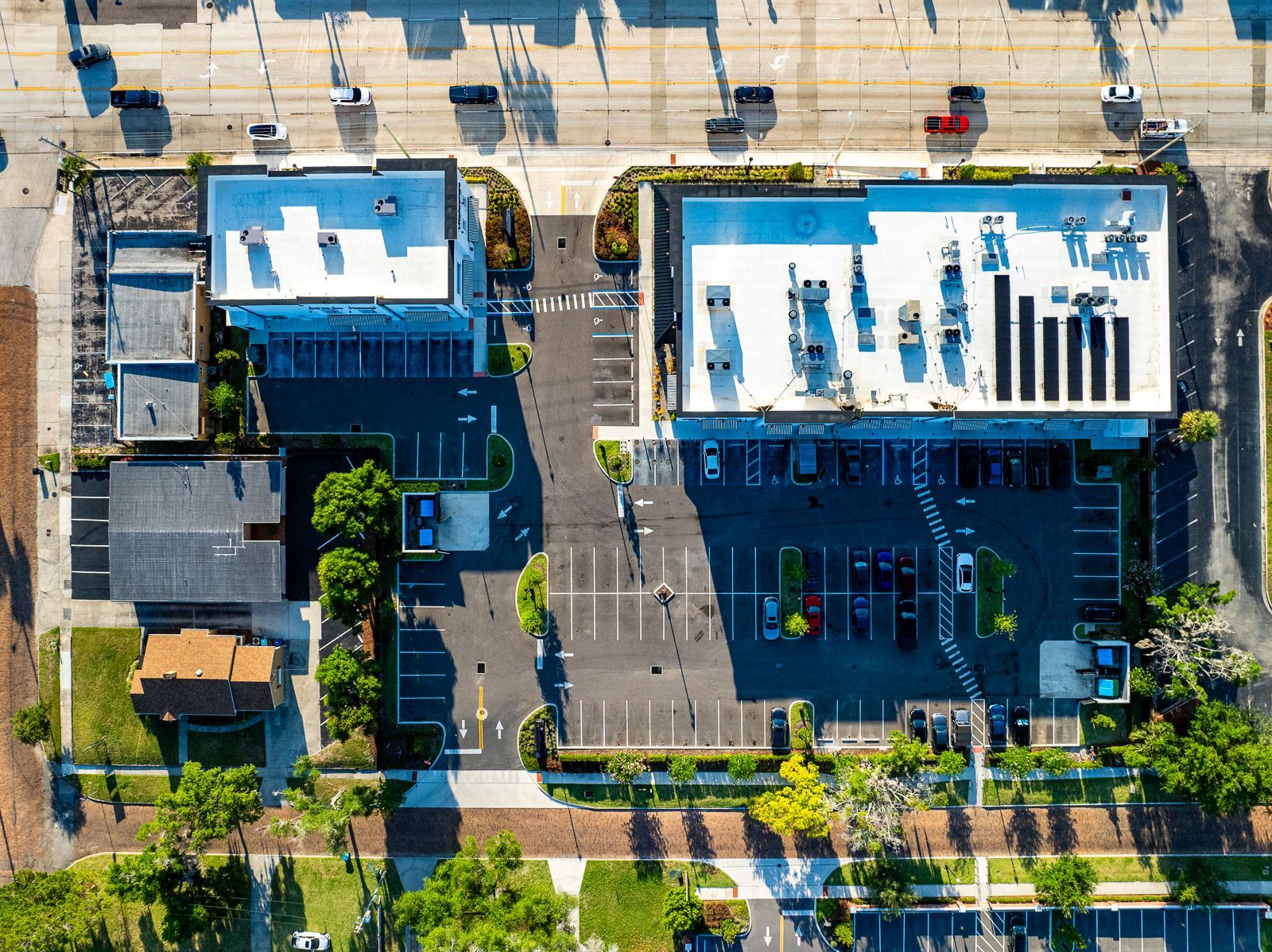 An aerial view of a parking lot and buildings in a city.