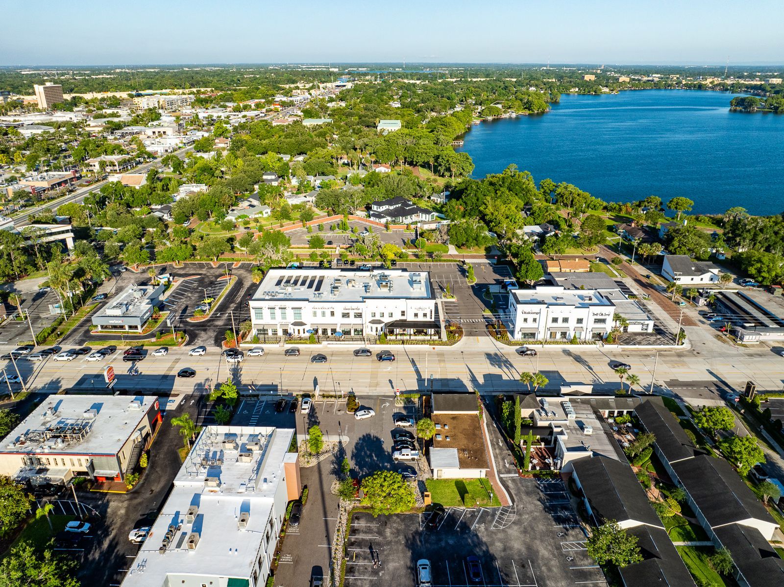 An aerial view of a city with a lake in the background