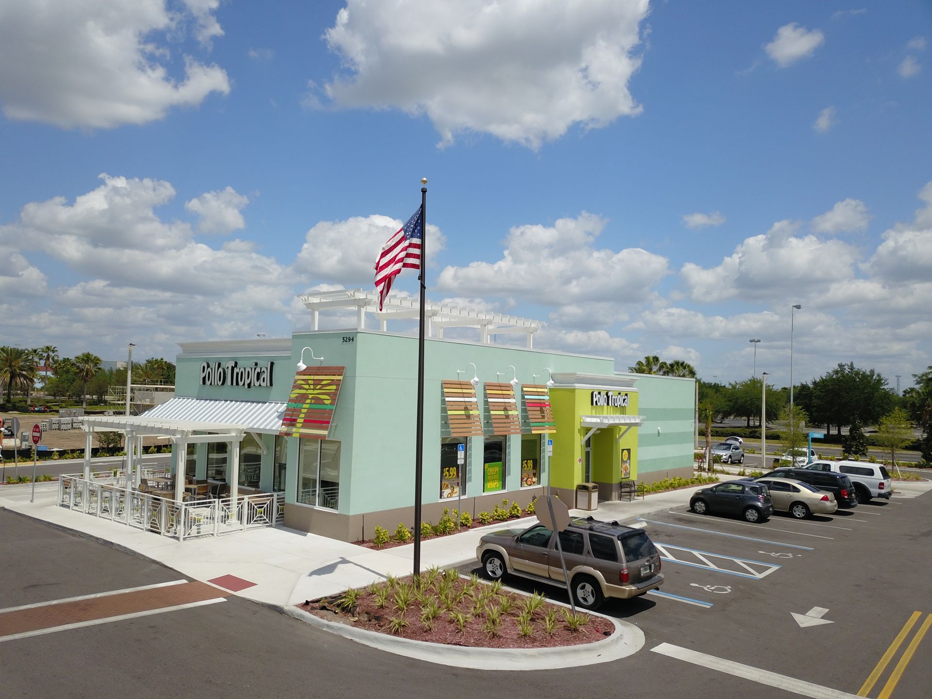 A mcdonald 's restaurant with cars parked in front of it