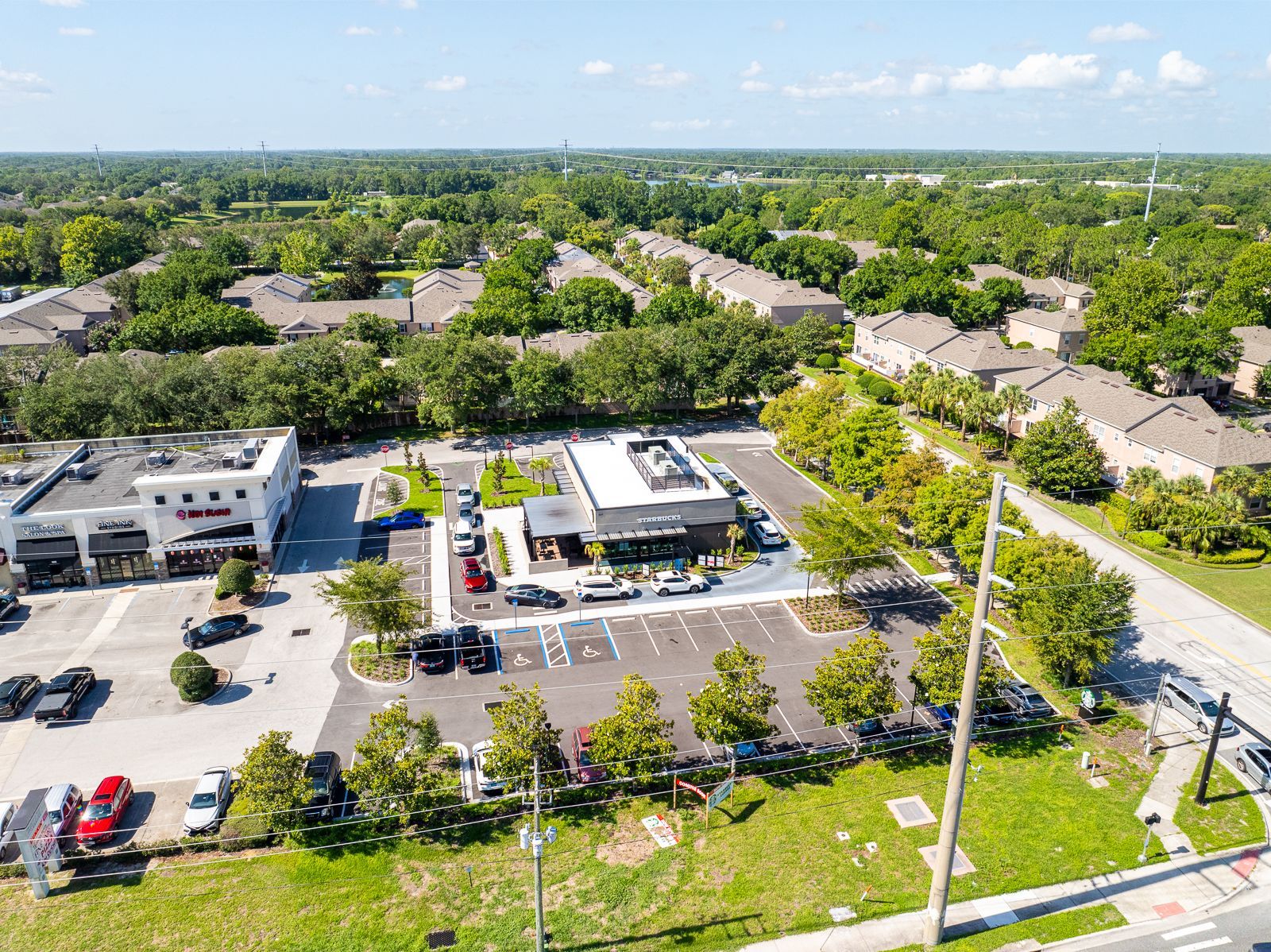 An aerial view of a residential area with a lot of trees and buildings.