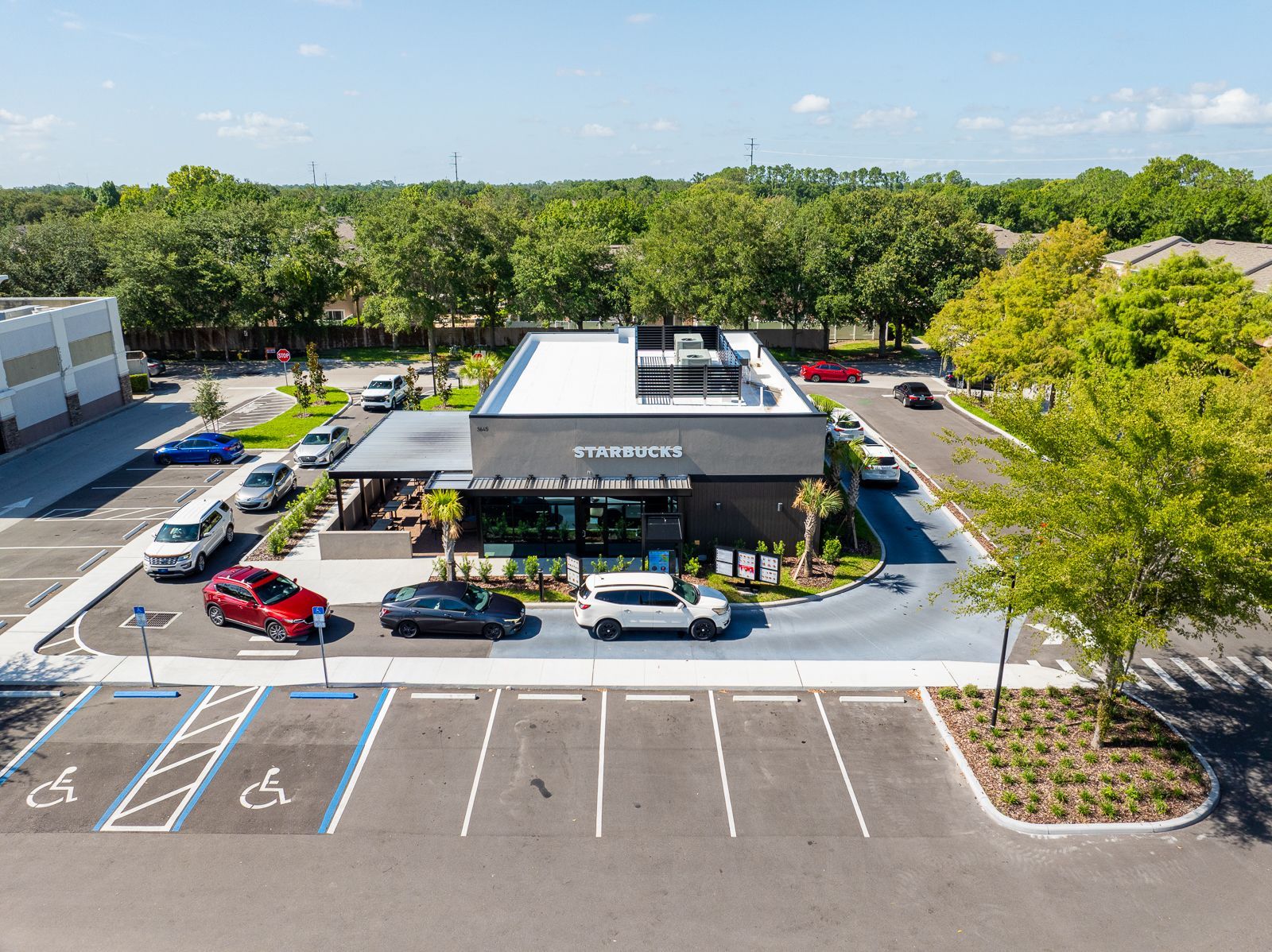 An aerial view of a restaurant with cars parked in front of it