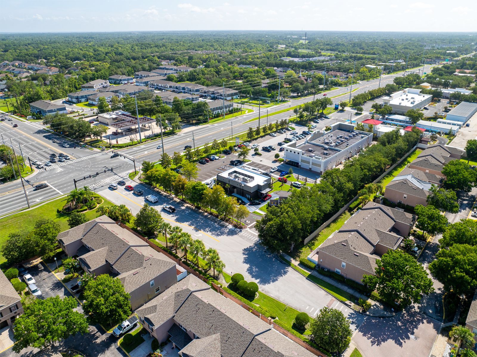 An aerial view of a residential area with lots of trees and houses.