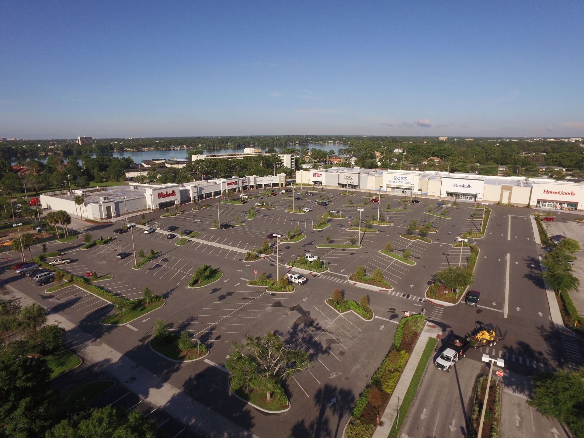 An aerial view of a large parking lot in front of a shopping mall.