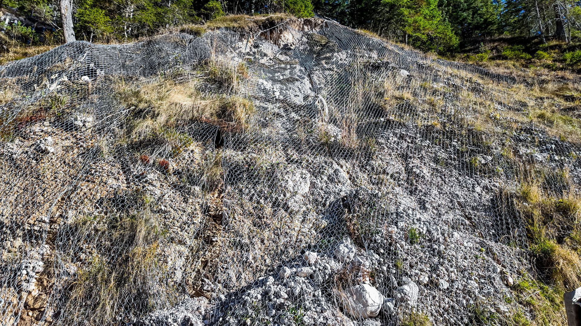 A large pile of rocks and grass on top of a hill.