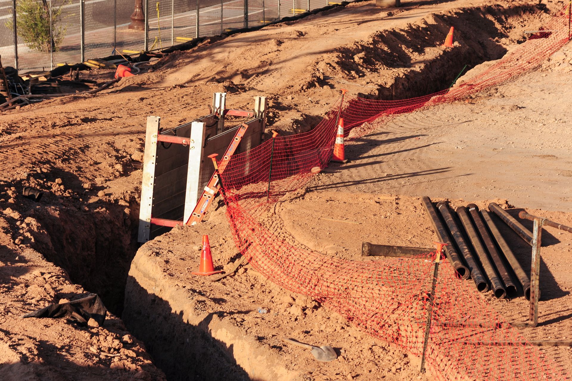 A construction site with a fence and cones around it