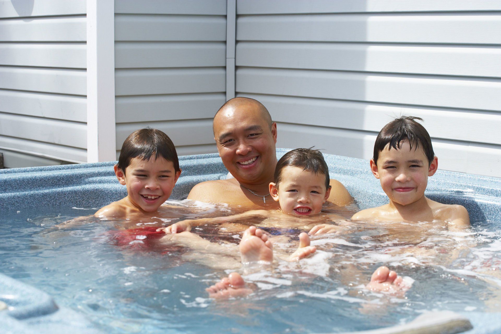 family enjoying a hot tub