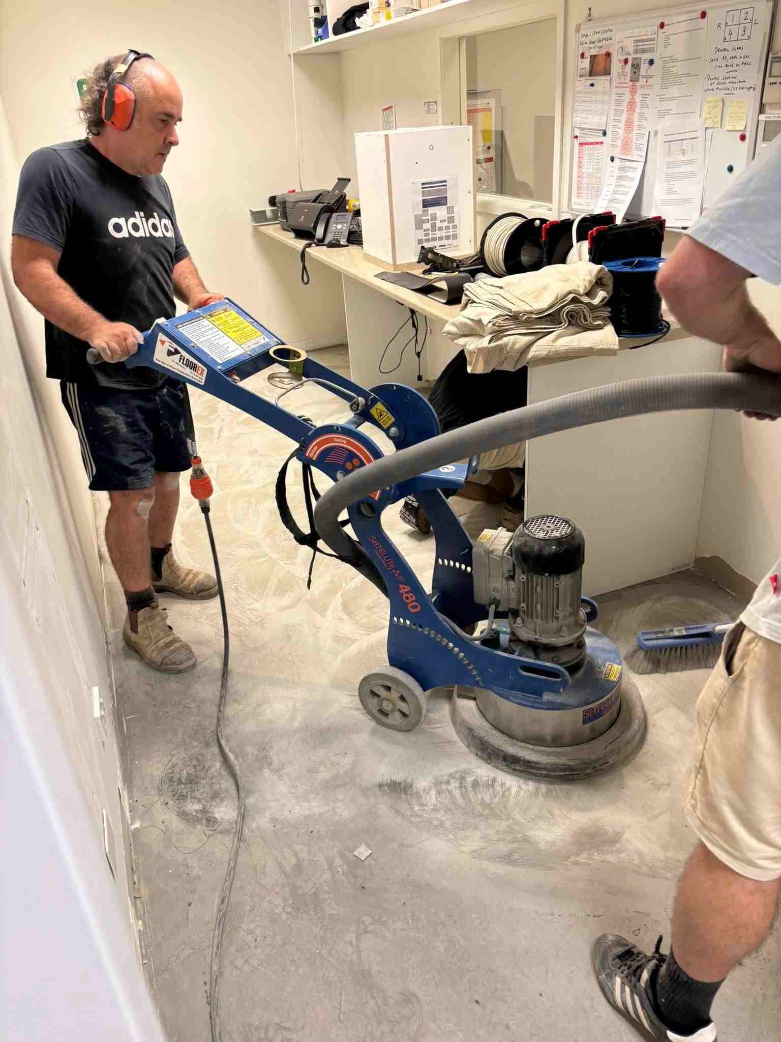 Man Grinding a Concrete Floor with A Large Machine Indoors — Gava Floor Centre in Byron Bay, NSW