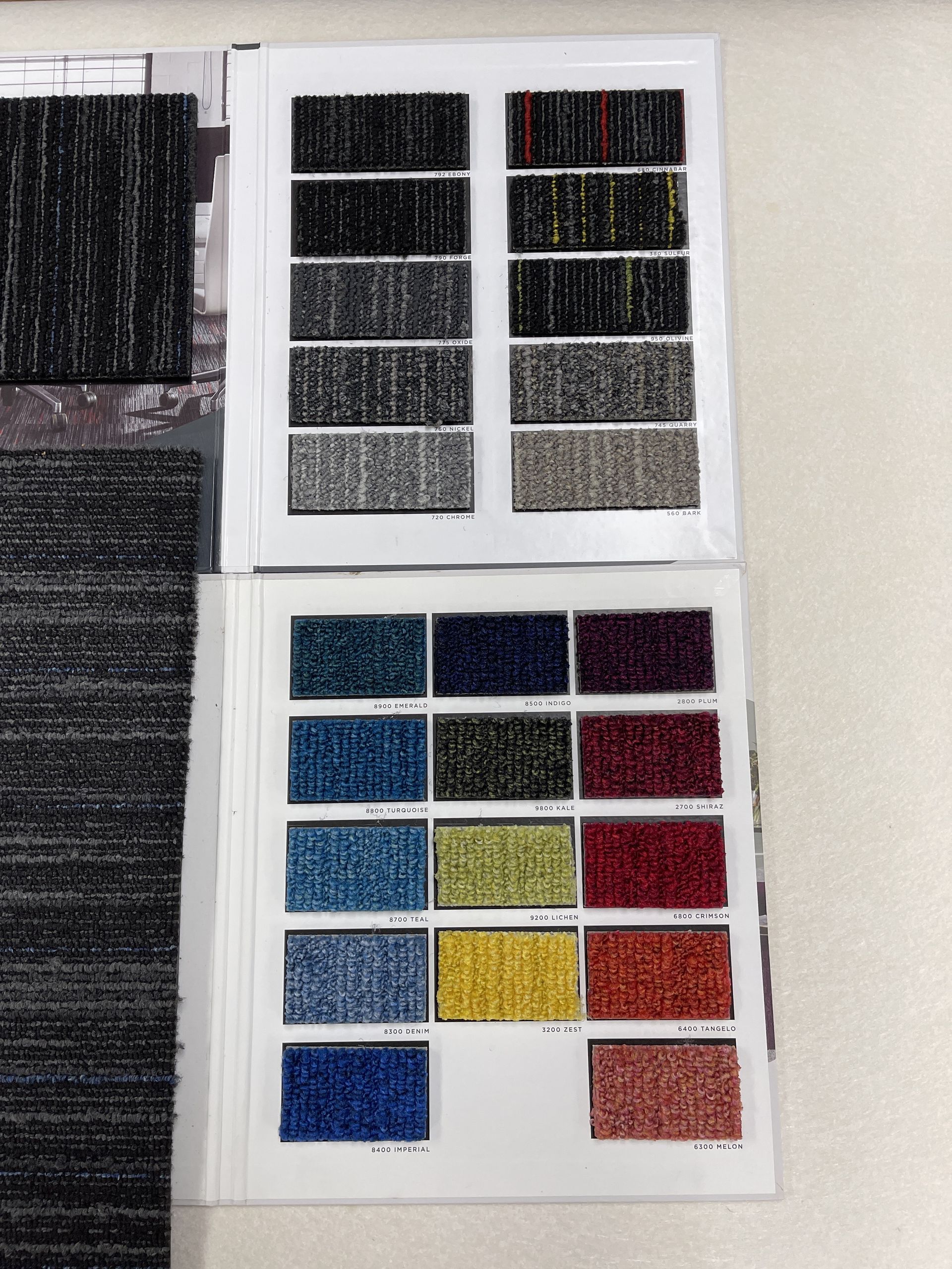 Carpet sample swatches in various colors, arranged in a book.