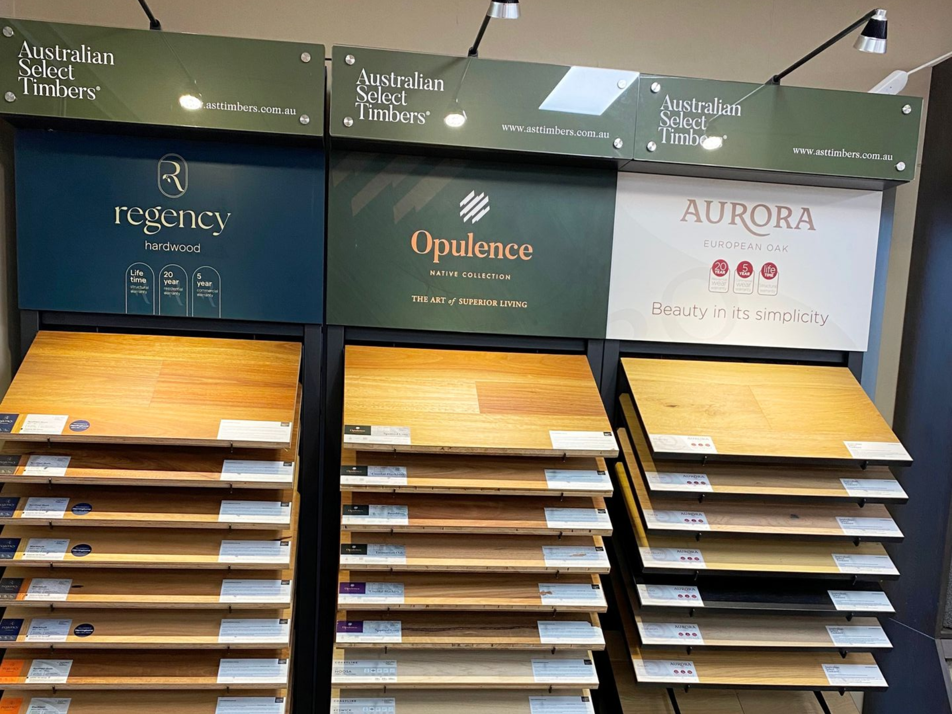 Display of Australian timber flooring samples with brand names: Regency, Opulence, and Aurora.