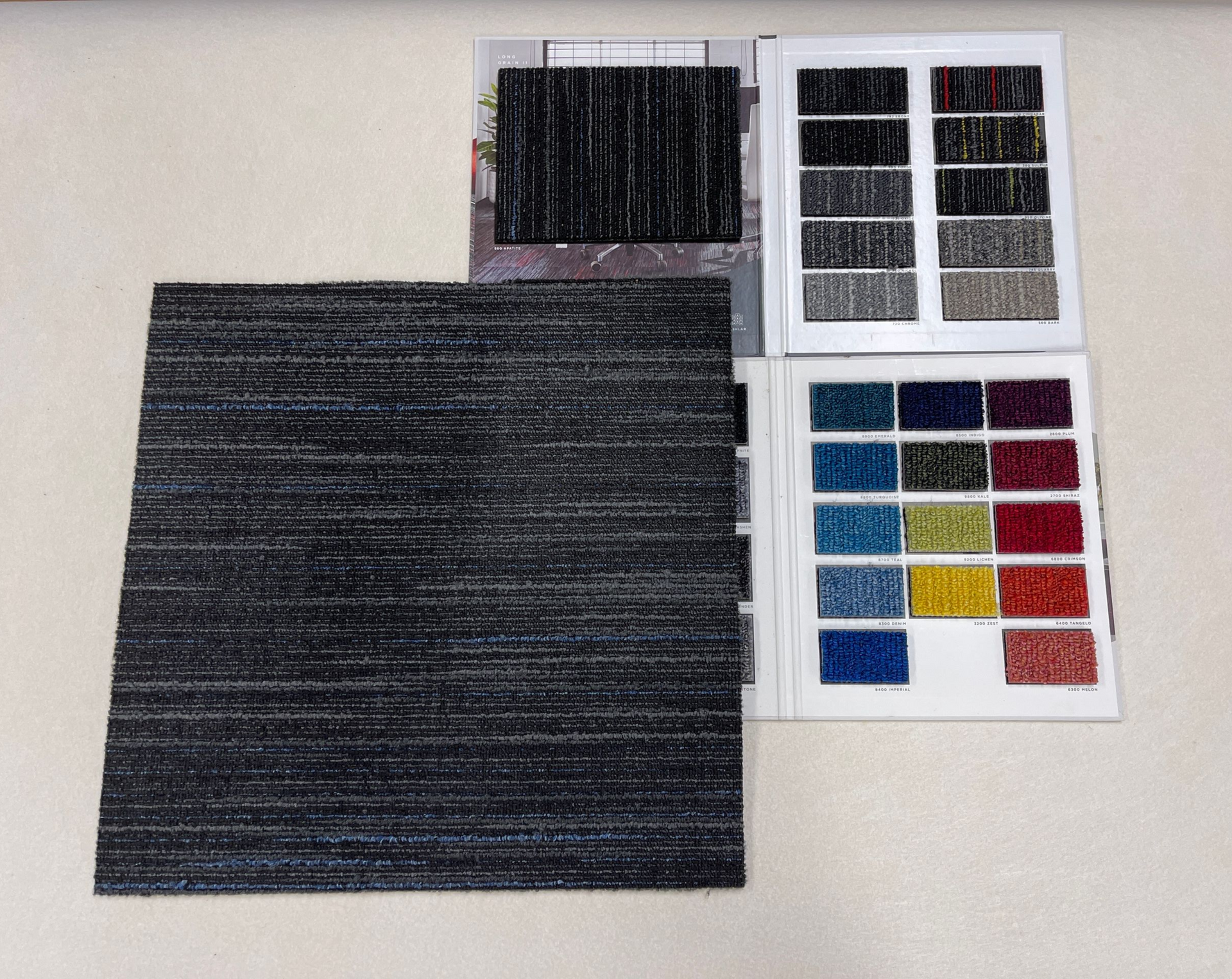 Carpet samples on a wall, showing various colors and textures.