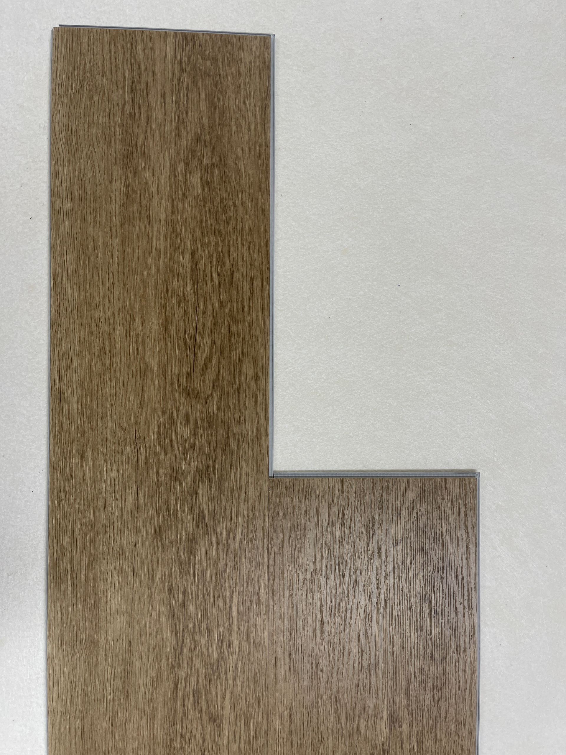 L-shaped brown wood flooring sample on a white background.
