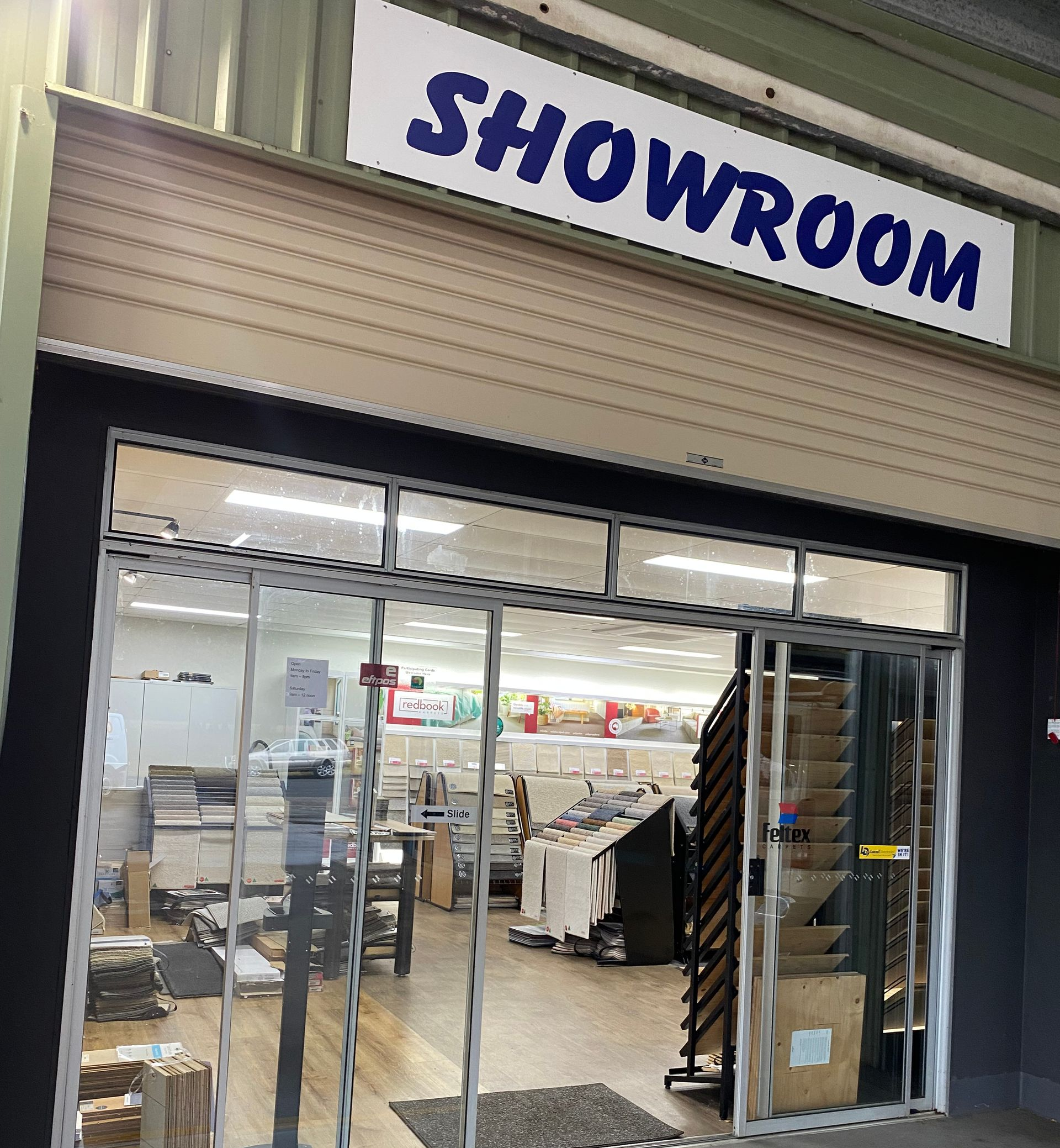 Showroom entrance with large glass doors and a 