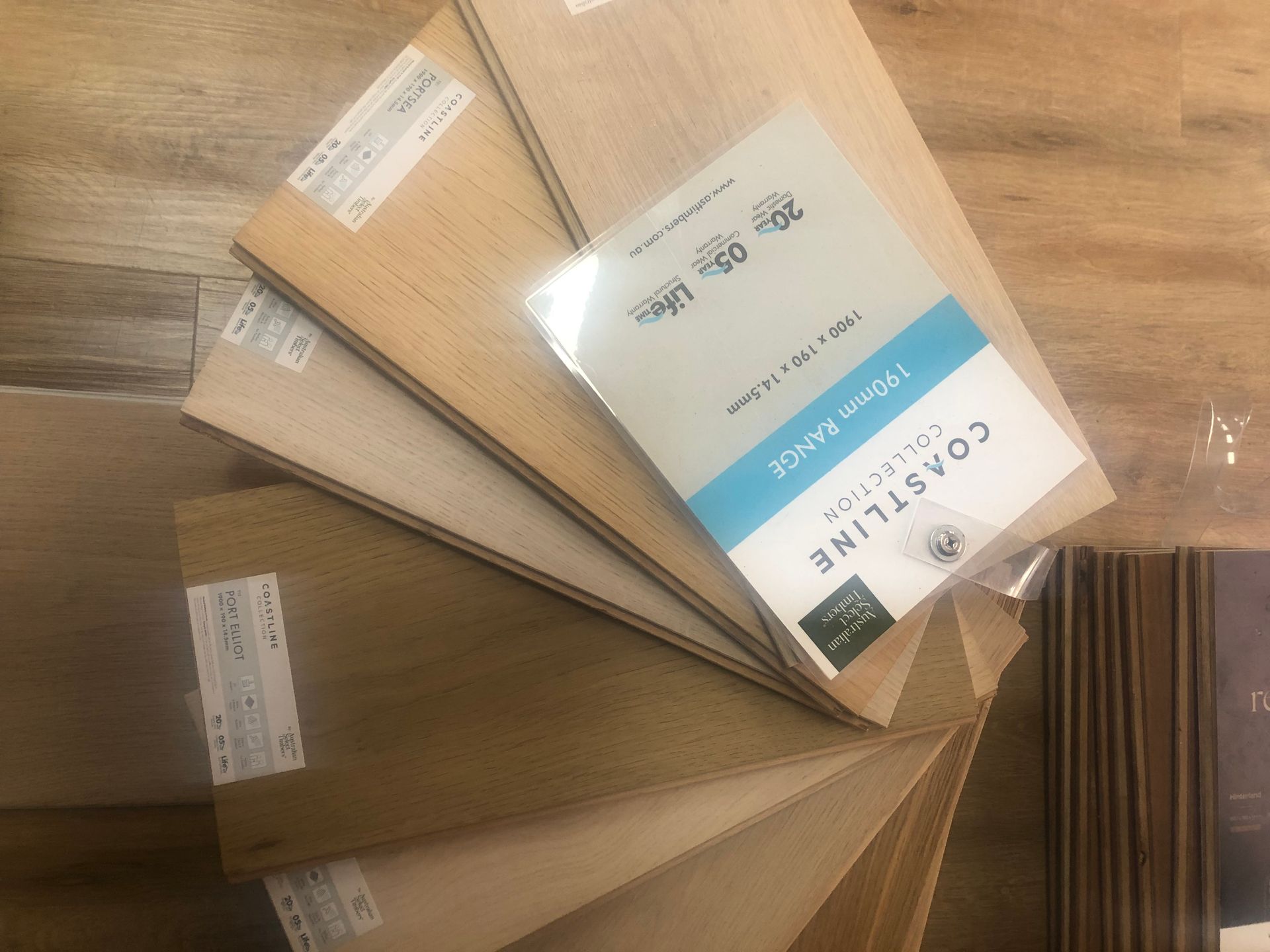 Samples of wood flooring arranged with product information booklet.