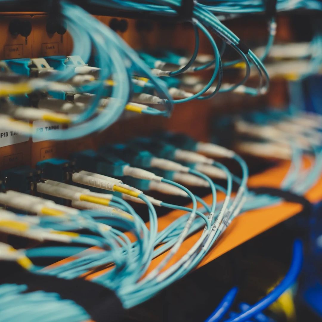 Blue network cables plugged into a server rack.
