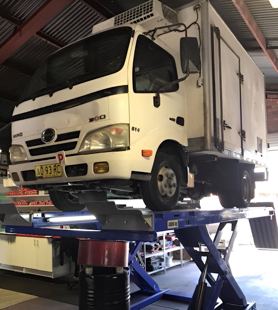 A White Truck With A License Plate — Cannon Automotive Services In East Maitland, NSW