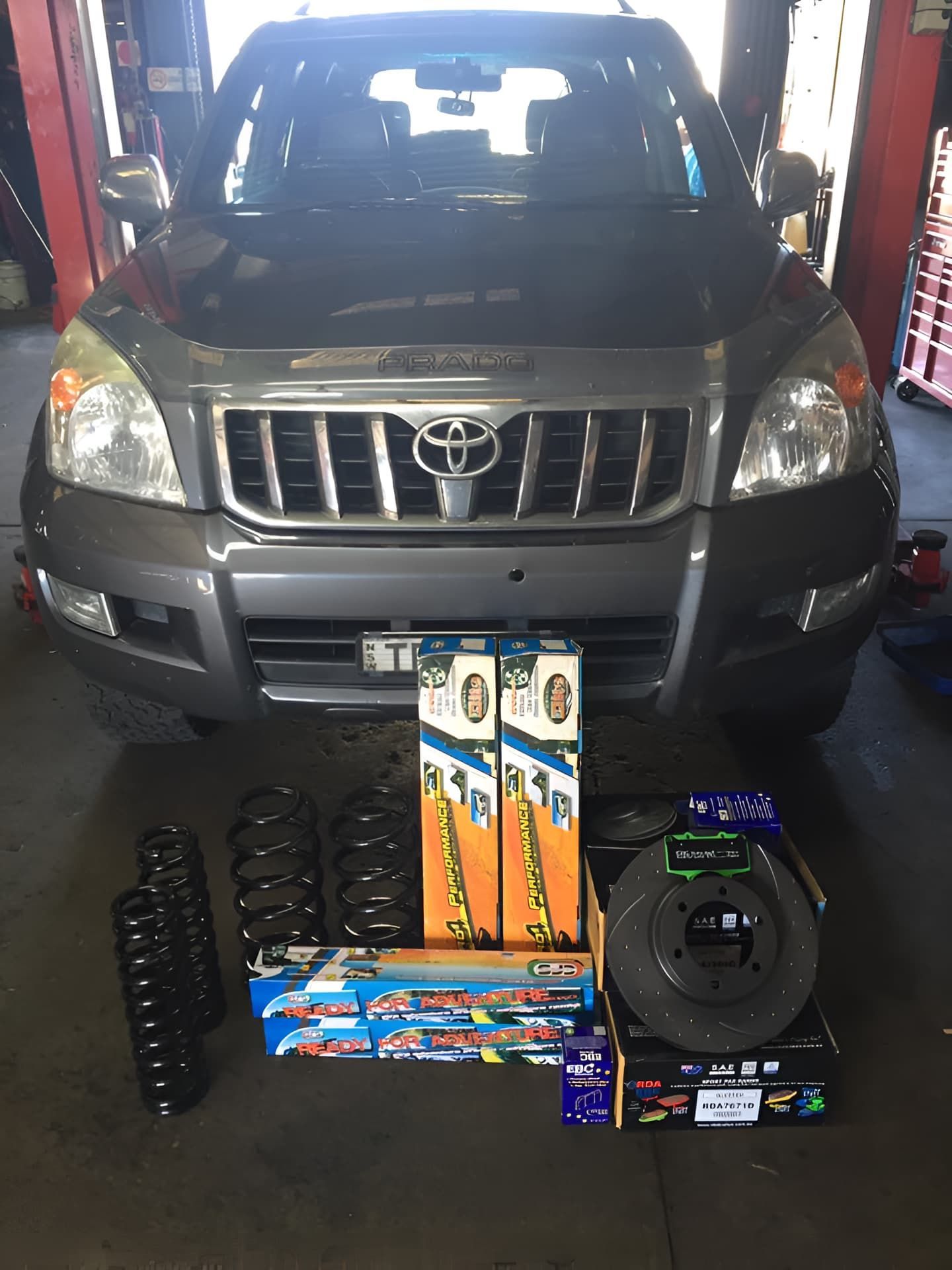 A Toyota Land Cruiser Is Sitting In A Garage And A Suspension Parts — Cannon Automotive Services In East Maitland, NSW