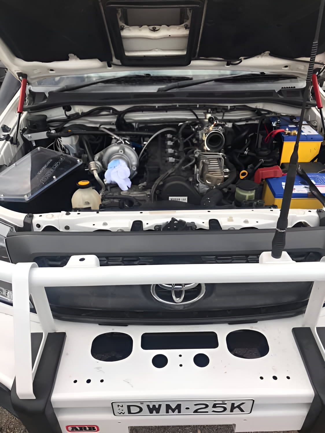 The Hood Of A White Toyota Is Open And The Engine Is Visible — Cannon Automotive Services In East Maitland, NSW