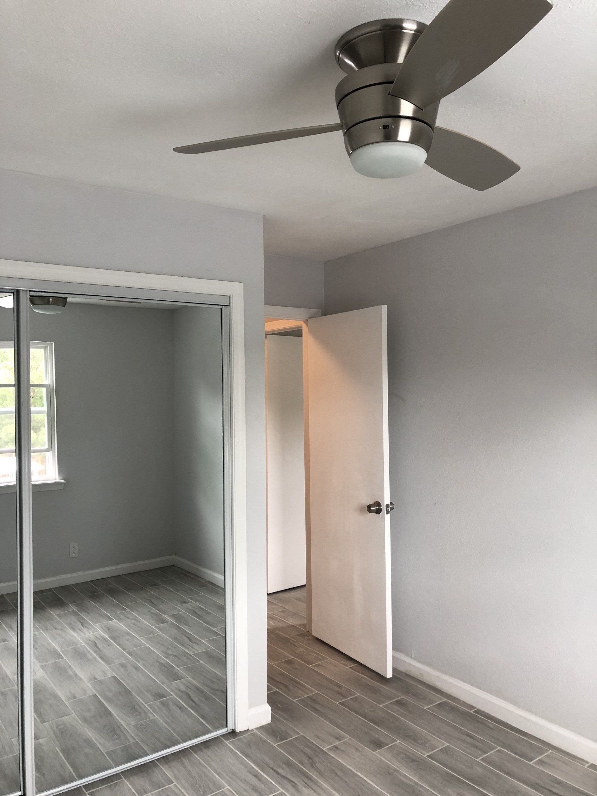 Bedroom image with light grey flooring and mirrored closet door at Summerwood Terrace Apartments in Amarillo, TX