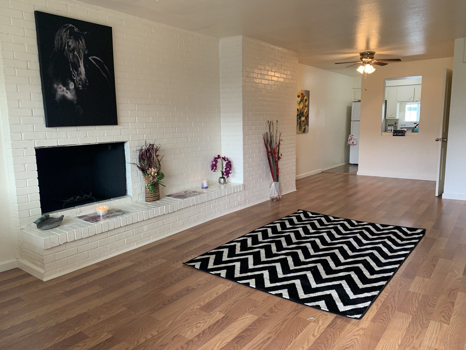 image of living room, with hardwood flooring and wall mounted tv at Greenbriar Terrace Apartments in Amarillo, TX