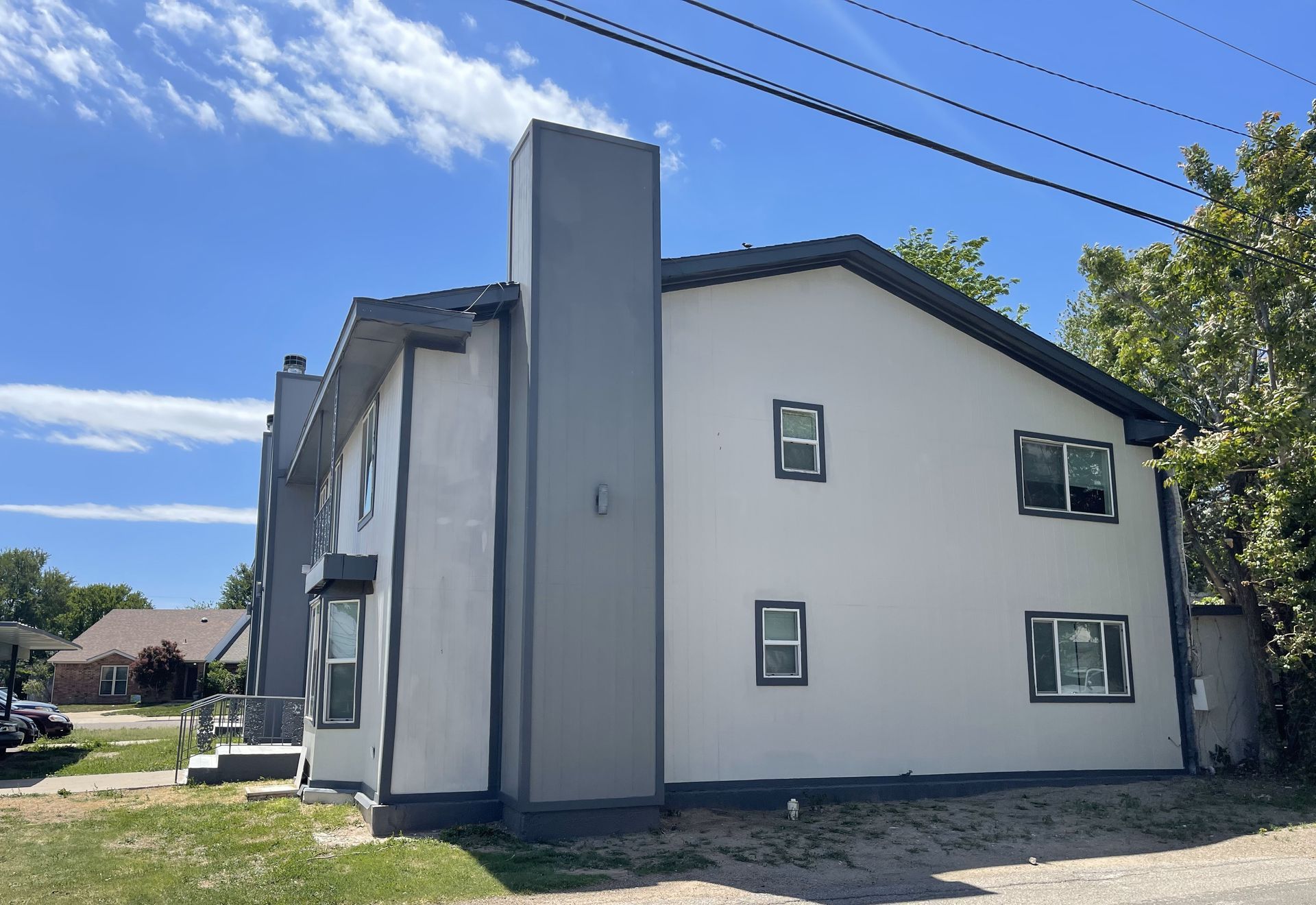 A large white building with a chimney on the side of it.