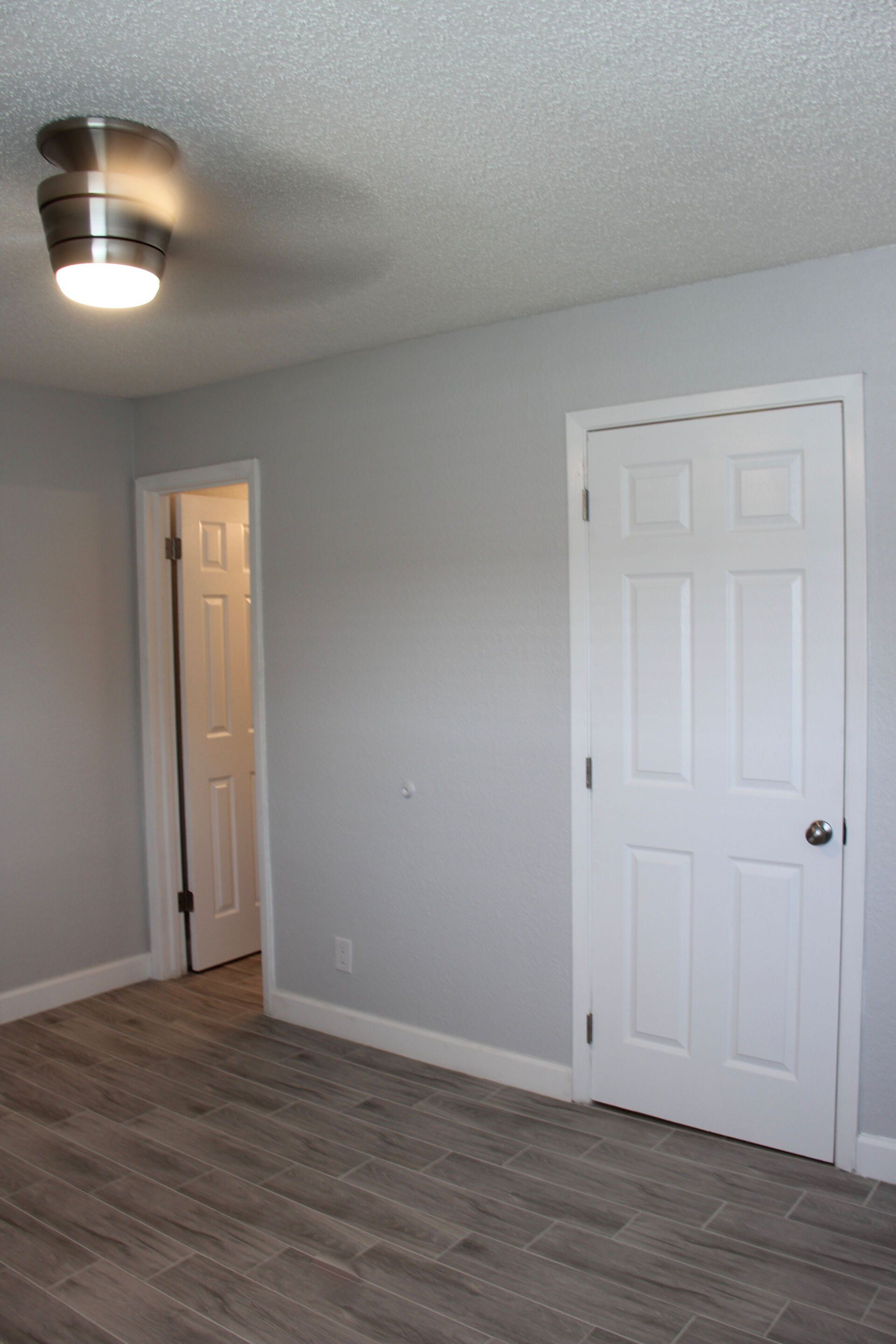 There is a ceiling fan in the corner of the room.