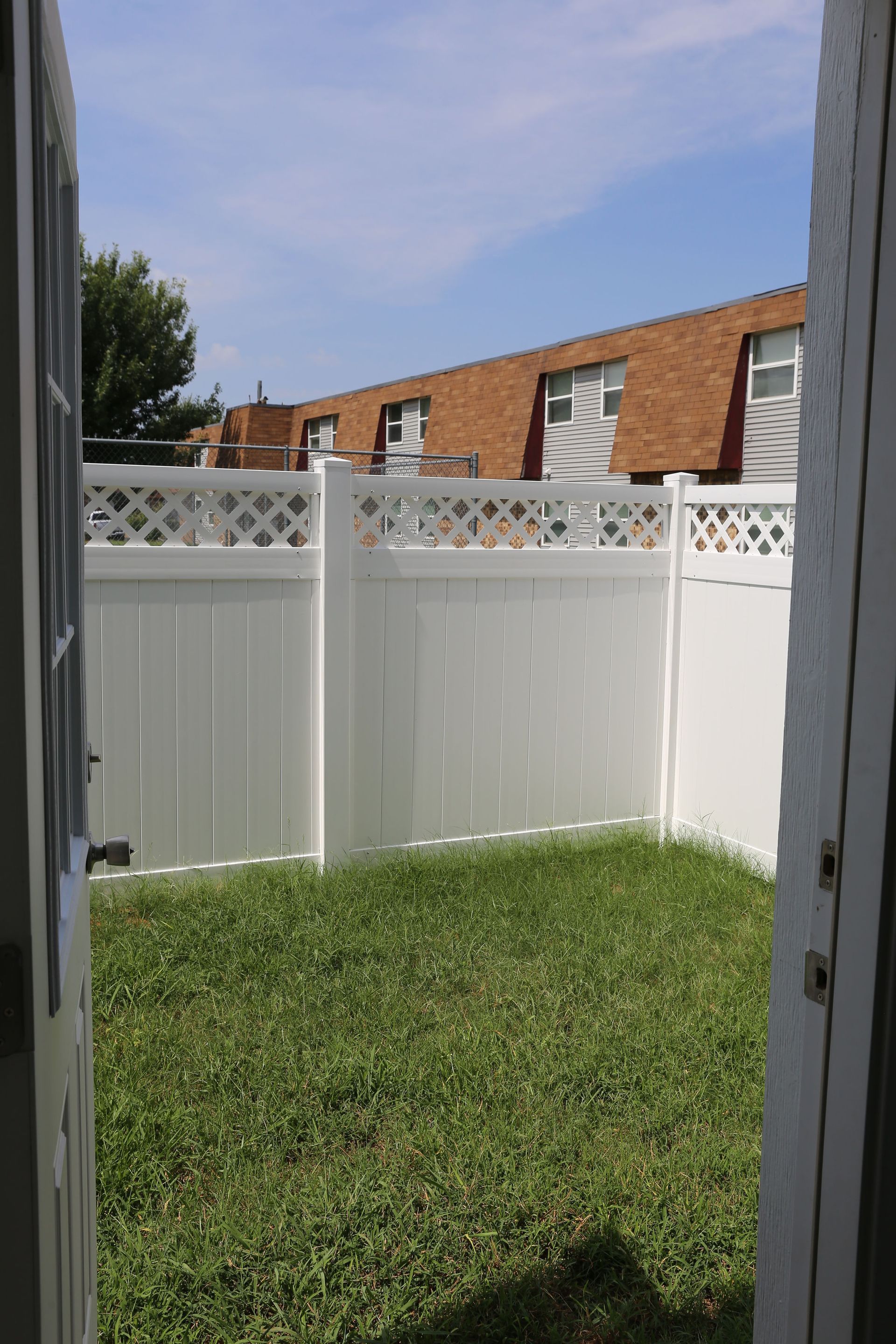 White fenced private backyard in select units at Lions Court Apartments in Wichita Falls TX