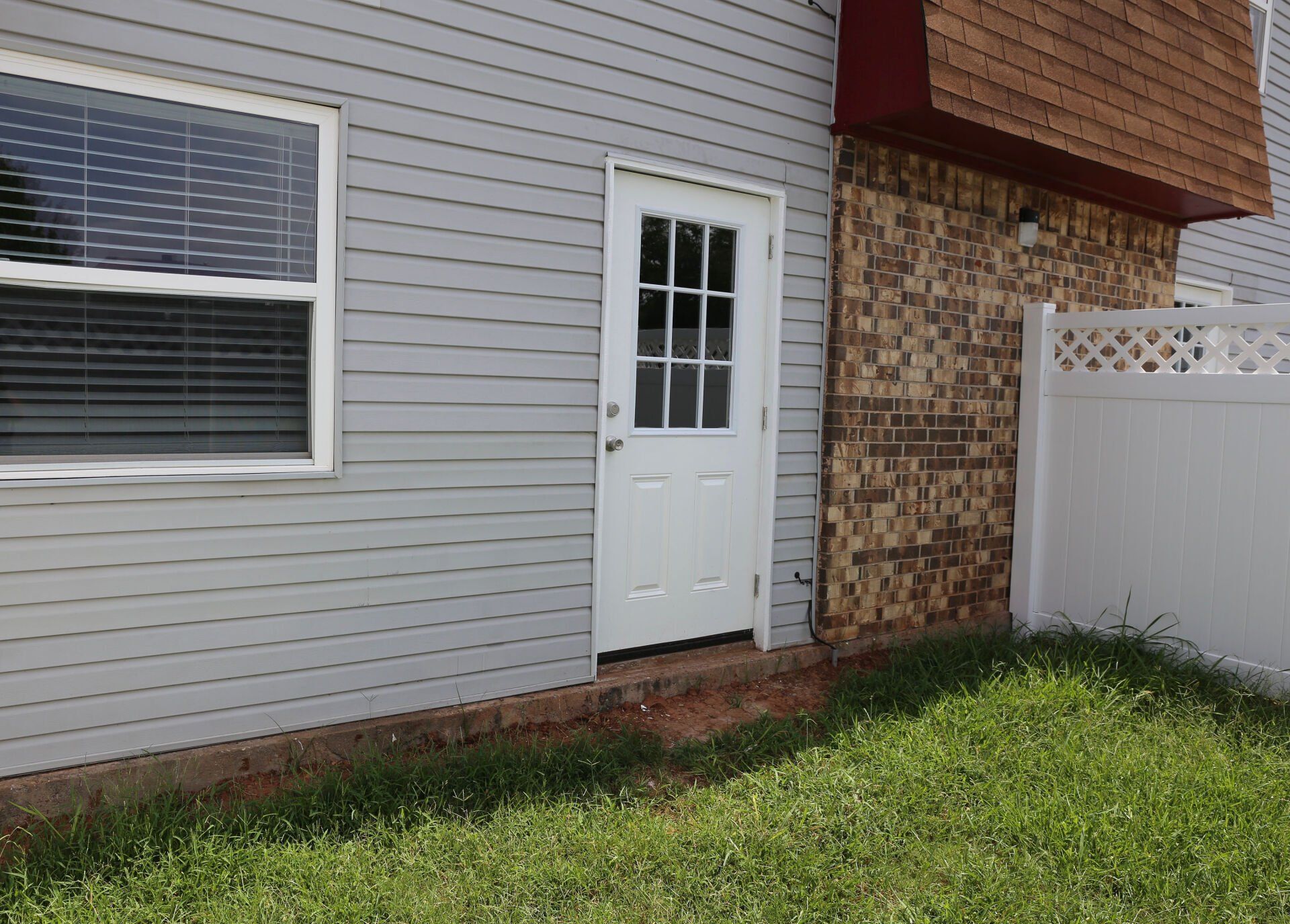 A house with a white fence and a white door