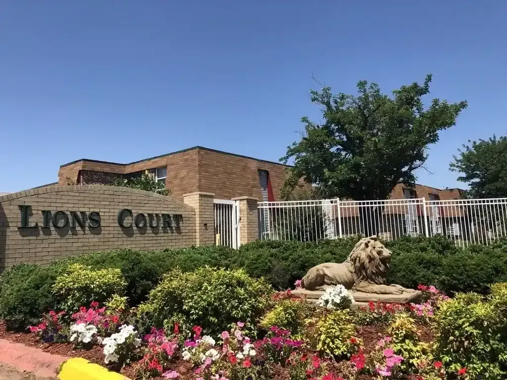 Image of flowerbed in front of the main entrance of Gated Apartments at Lions Court Apartments Wichita Falls TX