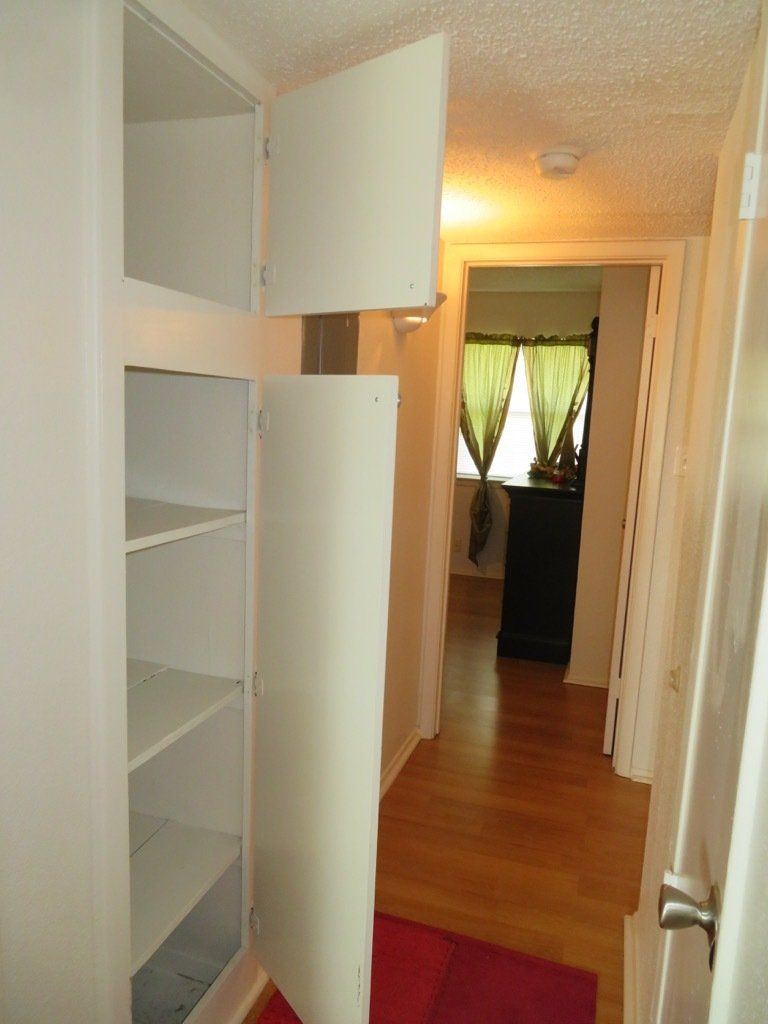 image of open white linen closet outside bathroom of a 2 bedroom at lions court apartments in Wichita Falls, TX