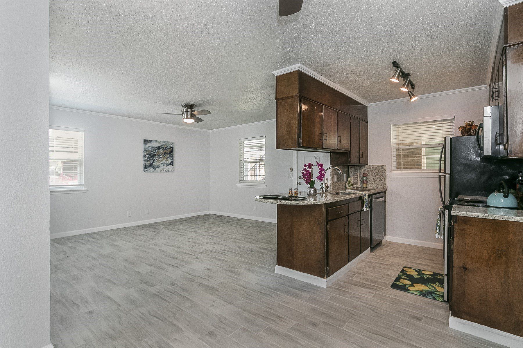 A kitchen with wooden cabinets and stainless steel appliances in a house.