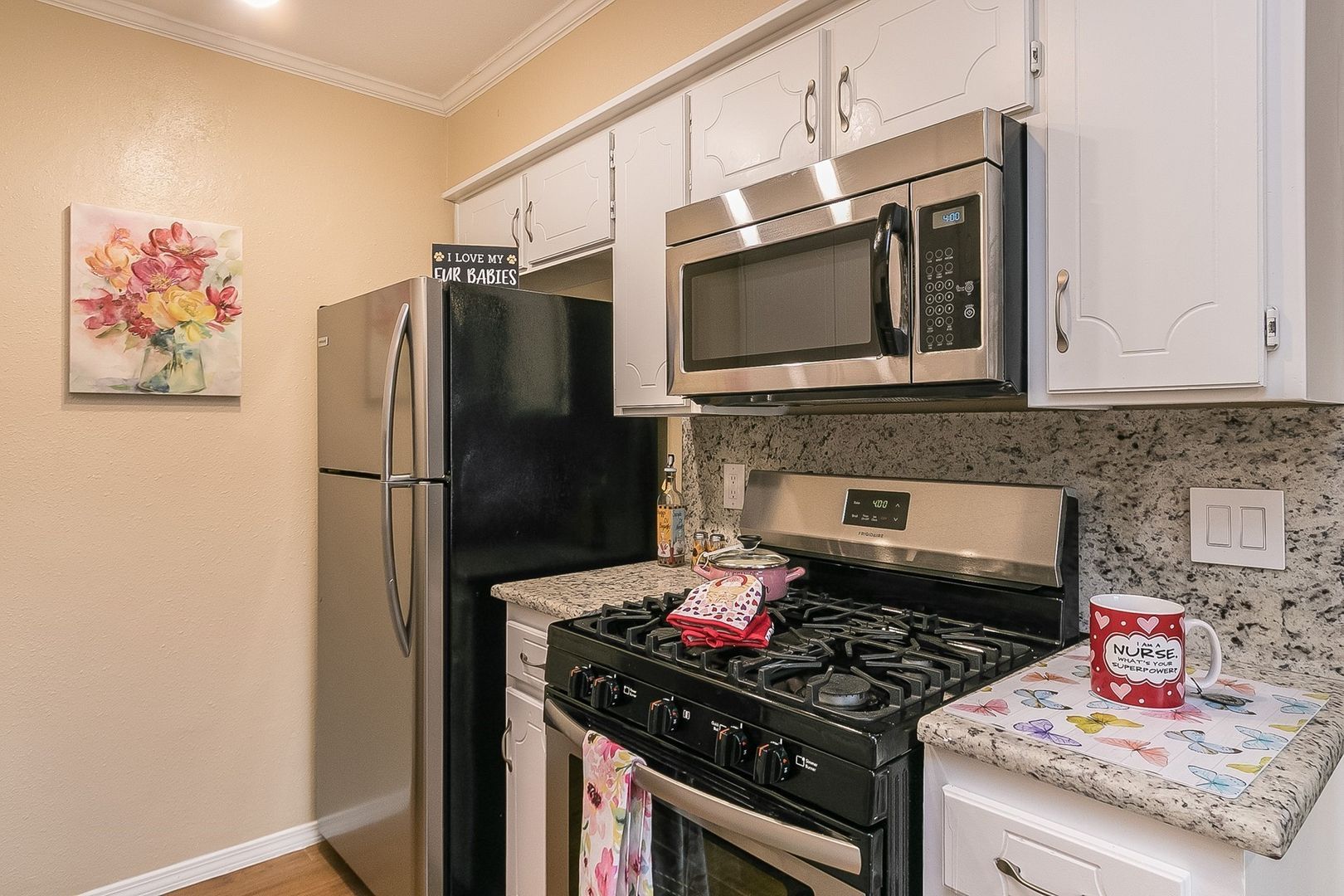 summerwood kitchen with white cabinetry, stone countertops
