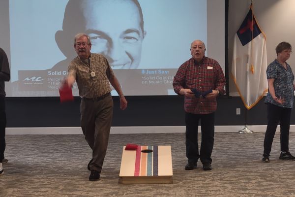 Retirement community residents play bean bag toss 