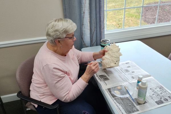 Resident participating in ceramics at Peterson Meadows