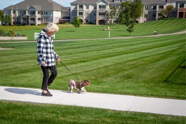 Resident walking her dog at Wesley Willows