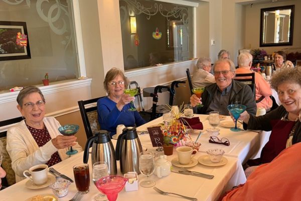 Independent senior living residents enjoy margaritas in the dining room at Peterson Meadows