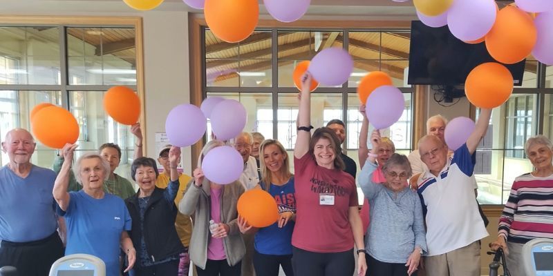 Seniors celebrating with balloons at Wesley Willows