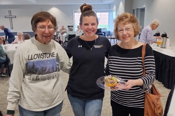 A staff member and residents pose for a picture at Peterson Meadows in Rockford, IL