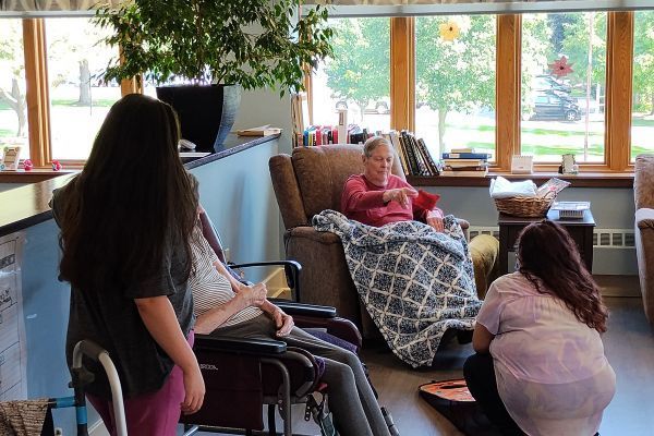 Resident plays a game at Kirk's Place Memory Care Center