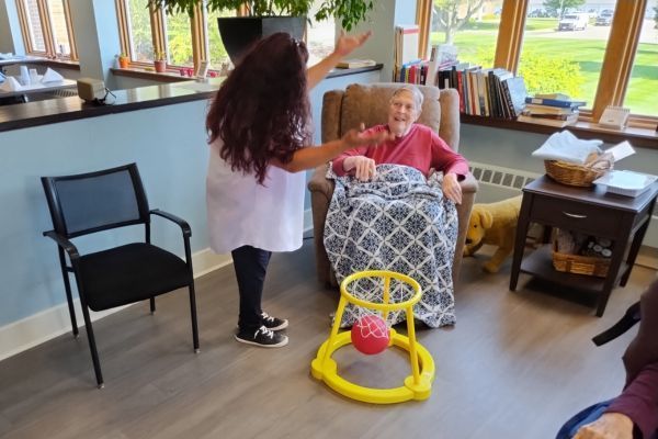 Memory care worker enjoying a game with a resident of Kirk's Place at Wesley Willows