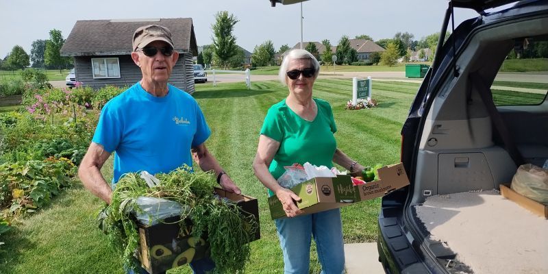 Residents of Wesley Willows gather produce donations to bring them to the Rock River Valley Pantry