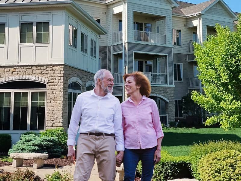 A couple stands on the campus of a senior living community in Rockford, IL