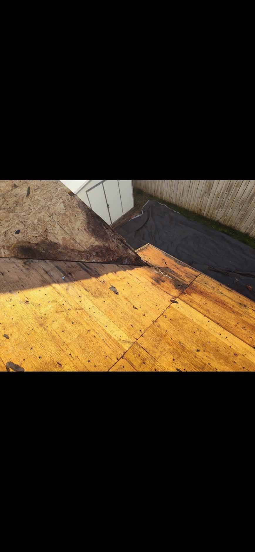 Wooden deck angled towards a building and a field.